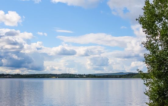 White clouds reflecting on a clear lake surface