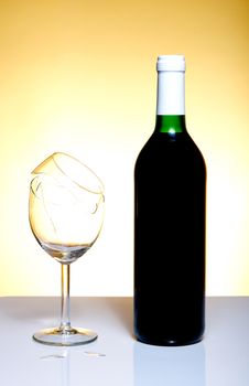 Vine bottle and broken glass on orange background