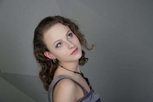 woman in a grey dress with a grey background