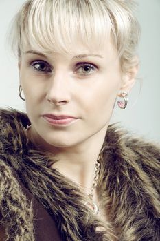 close up studio portrait of beautiful woman with coat