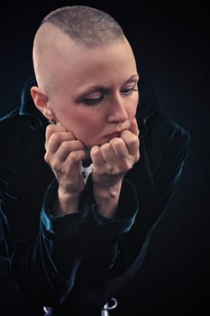 Bald young woman posing in studio