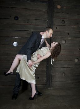 man and a woman dancing against the boards