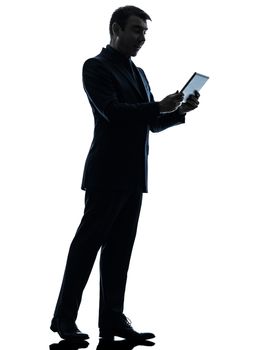 one caucasian business man surprised holding digital tablet  in silhouette on white background