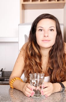 A young woman with a glass of water.