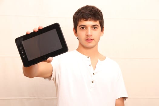 A young, latin man with a Tablet PC, face in focus
