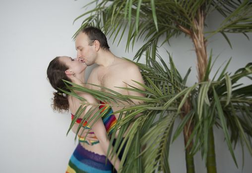 young couple under a palm tree in the Studio