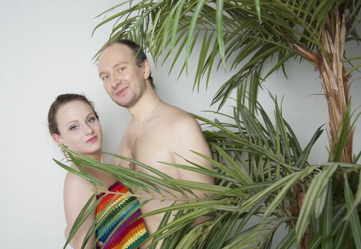 young couple under a palm tree in the Studio