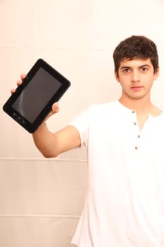 A young, latin man with a Tablet PC, tablet pc in focus
