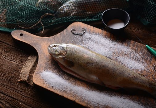 Fresh trouts on wooden background