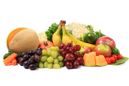 Group of colorful fruits and vegetables like grapes, bananas, and cauliflower on a white background