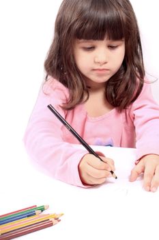 Cute little preschool girl  drawing with pencils on white 