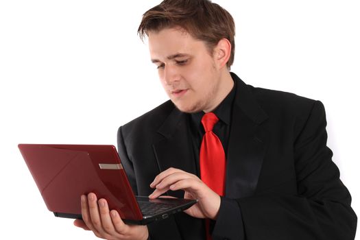 Handsome young businessman holding small computer laptop with a wondering expression on white background