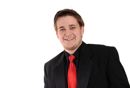 Handsome smiling, young businessman in black formal suit with red tie