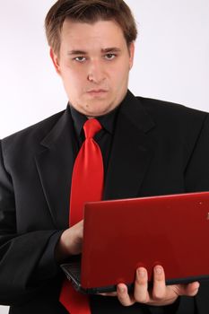 Handsome young businessman holding small netbook computer on white background