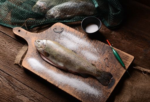 Fresh trouts on wooden background
