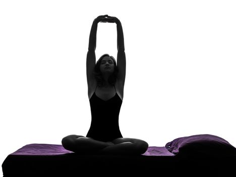 one woman waking up stretching arms in bed silhouette studio on white background