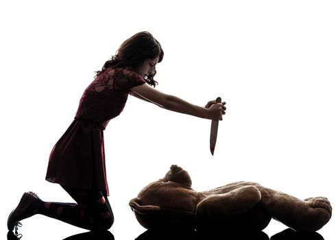 one caucasian strange young woman killing her teddy bear in silhouette white background