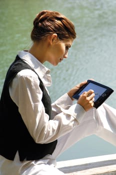 beautiful young sexy business woman with laptop at the sea