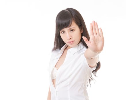 Asian woman with shirt unbuttoned making stop hand sign