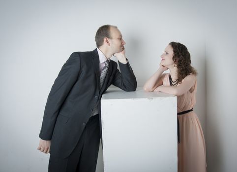 young man and woman look at each other in the Studio