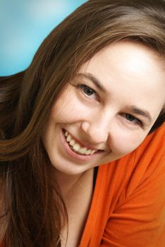 A woman smiles happily with a confident pose.