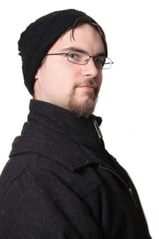 Handsome young man with glasses wearing winter clothing on a white background