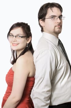 Cute young couple happy together standing back to back on a white background