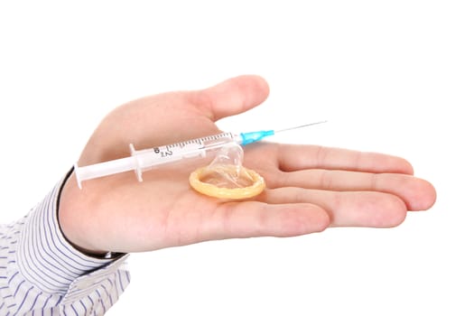 Syringe and Condom on a Palm close-up Isolated on the White