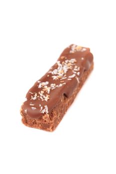 Piece of chocolate fudge with coconut on a white background