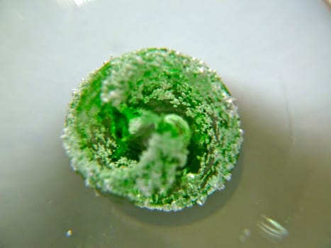 Bright green patterned swirl in a glass globe