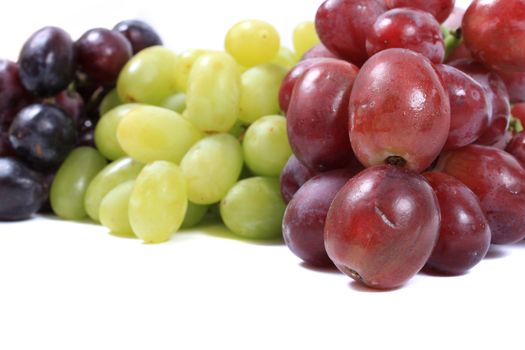 Three different types of grapes in red, green and black