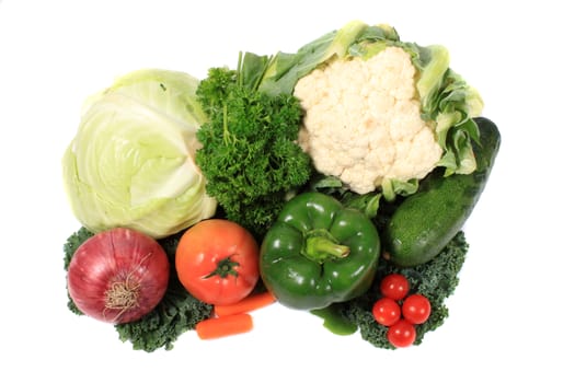 Fresh colorful vegetables like cabbage, tomatoes, onion and kale on a white background