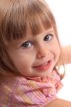 Close up portrait of little two year old girl smiling on a white background