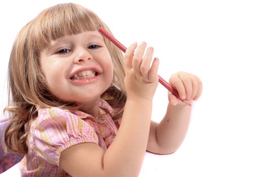 Cute little two year old girl holds pencil crayon and smiles