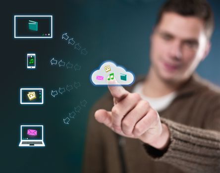 Young man working with multimedia cloud