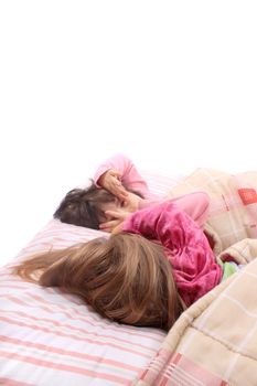 Sleepy little girls just waking up in bed