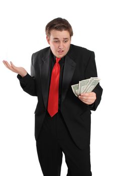 Attractive young man in black suit holding one dollar bills on a white background with surprised or shocked expression