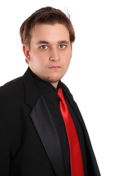 Handsome young businessman in black formal suit with red tie