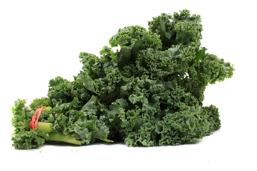 Fresh green leafy kale on a white background