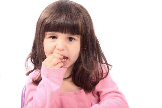 Cute young four year old child holding her tooth which may be loose or aching