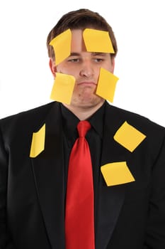  overwhelmed from work, businessman with yellow sticky note paper on face and suit on a white background