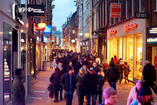 AMSTERDAM, NETHERLANDS - MARCH 01, 2014: Unidentified people walking on Kalverstraat - main shopping street of Amsterdam. The Kalverstraat is the most expensive shopping street in the Netherlands.