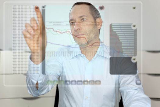 Businessman works with futureistic computer display