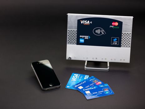 Aachen, Germany - August 05, 2012 - Studioshot of payment variations ( Apple iPhone 4, Visa paywve, mastercard paypass) in front of a NFC terminal wich accepts visa, mastercard, american express and girogo contactless payments.