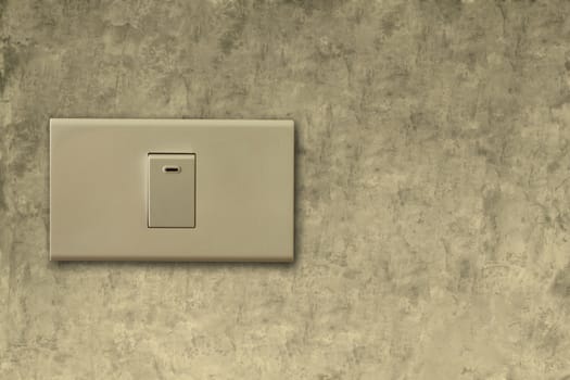 Light switch on the cement wall background