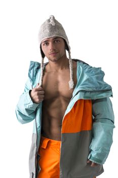 Attractive young male skier or snowboarder with open coat on naked muscular torso
