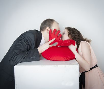 young man and woman kissing for red heart