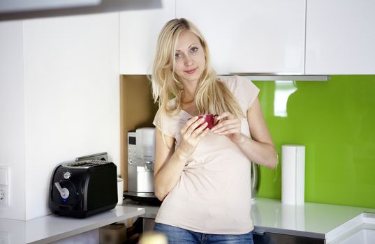 young woman has her coffee break at home