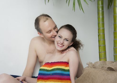 young couple under a palm tree in the Studio