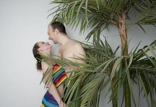 young couple under a palm tree in the Studio